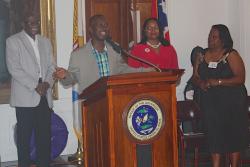 Camille 'King Derby' Macedon, at podium, accepts his award from the Virgin Islands Puerto Rico Friendship Committee Saturday. Camille 'King Derby' Macedon, at podium, accepts his award from the Virgin Islands Puerto Rico Friendship Committee Saturday.